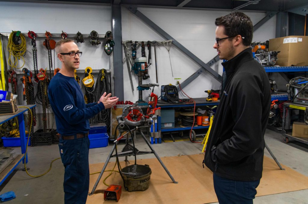 Grant Luszczek (right) speaking with Mike Fraser, CWB Welding Supervisor from Tri-Mach’s Skilled Trades Excellence Centre.