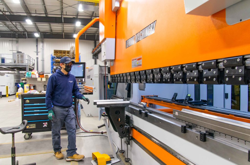 Press Brake operator Bruce Tjandra hard at work. This machine is used to bend steel sheets.